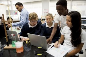 group of students checking computer