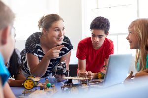 teacher with students teaching robotics