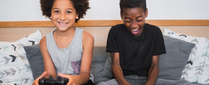 young boys gaming on couch