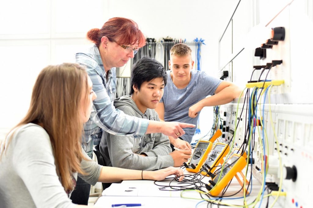 Teacher working with high school students