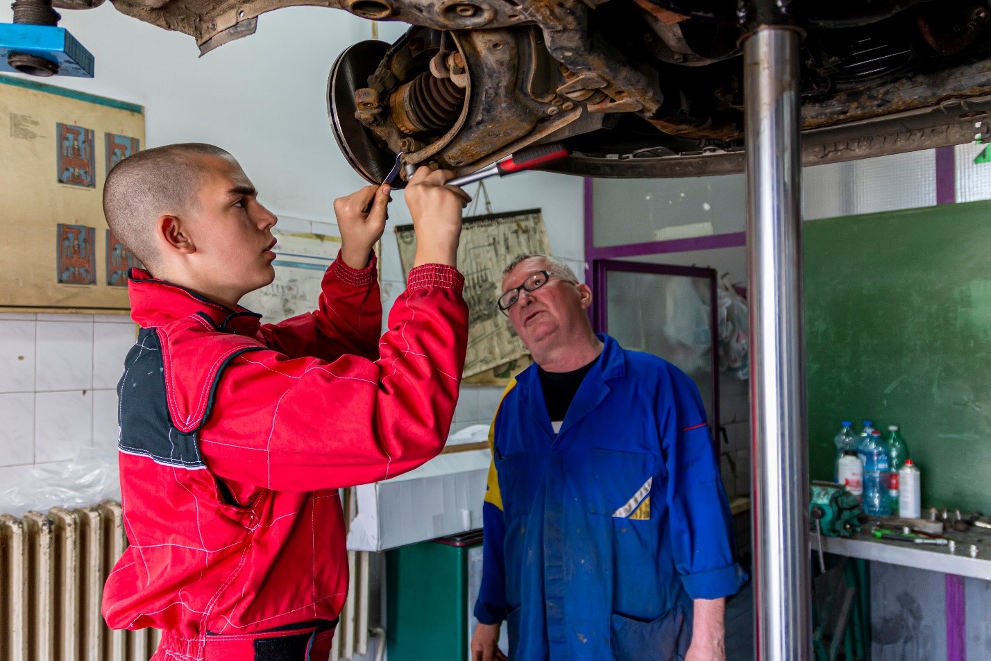 Teenager working on car in CTE class