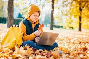 Child sitting in leaves